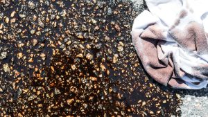 oil spill on cement with an oily rag