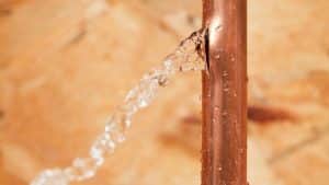 Copper pipe leaking water droplets